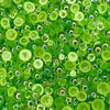 A close-up view of Sour Apple Bubbles embellishment mix featuring transparent iridescent green baubles.
