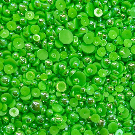A close-up view of small, round, green glow-stick acrylic flat-back baubles embellishments.