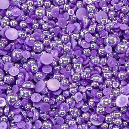 A close-up view of eggplant purple acrylic flat-back baubles embellishment mix.
