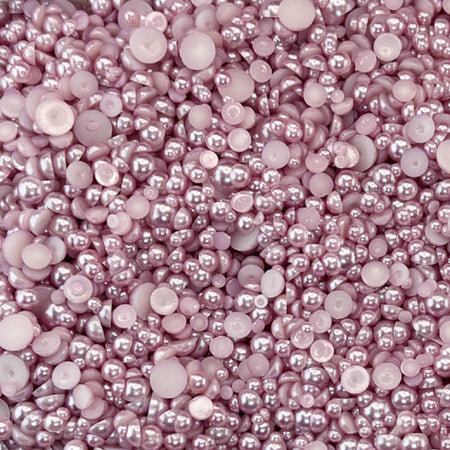 A close-up view of mauve-colored acrylic flat-back baubles embellishment mix from Trinity Stamps.