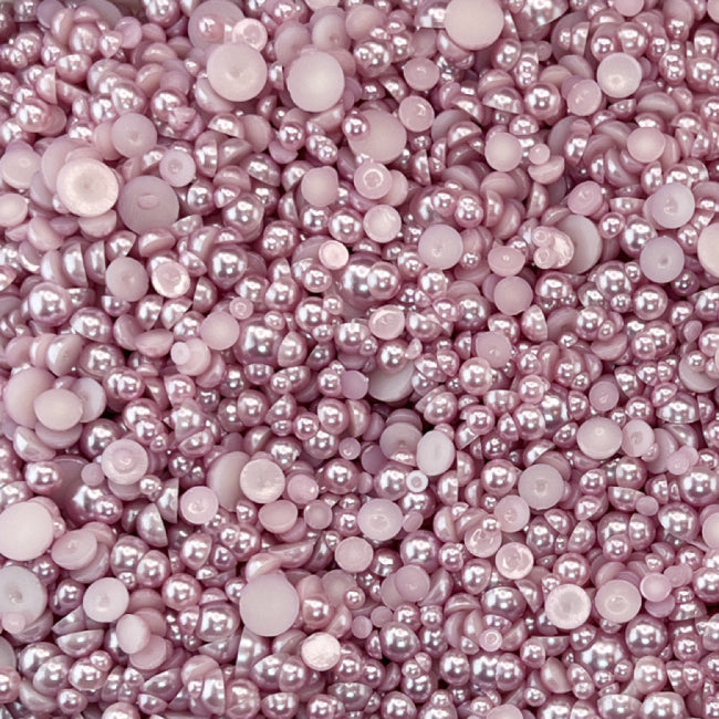 A close-up view of mauve-colored acrylic flat-back baubles embellishment mix from Trinity Stamps.