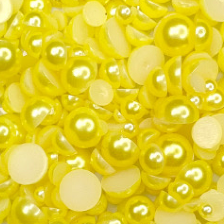 A close-up image of yellow satin bauble embellishments from Trinity Stamps, used for crafting and decoration.