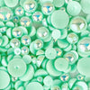 A close-up of mirrored mint acrylic flat-back baubles embellishment mix, presented on a transparent background.
