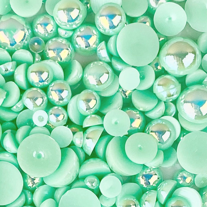 A close-up of mirrored mint acrylic flat-back baubles embellishment mix, presented on a transparent background.