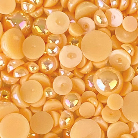 A close-up image of flat-back acrylic pearls in varying shades of orange and yellow, with a label stating 'CANTALOUPE ACRYLIC FLAT-BACK BAUBLES EMBELLISHMENT MIX'.