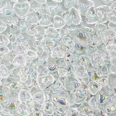 A variety of flat-backed bubble heart embellishments in different sizes, iridescent and transparent, displayed in a plastic storage container.