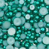 A collection of teal green satin bauble embellishments of various sizes, packaged in a plastic storage box with the label 'Teal Temptation Teal Green Satin Bauble Embellishment Mix' from Trinity Stamps.