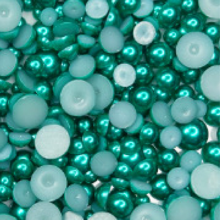 A collection of teal green satin bauble embellishments of various sizes, packaged in a plastic storage box with the label 'Teal Temptation Teal Green Satin Bauble Embellishment Mix' from Trinity Stamps.
