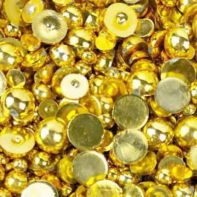 A close-up view of a mix of golden flat-back beads in assorted sizes, labeled as 'GORGEOUS GOLD BAUBLES' from Gorgeous Golden Baubles Embellishment Mix.